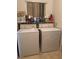 Convenient laundry room with washer, dryer, and storage shelves at 4382 Valley Regal Way, North Las Vegas, NV 89032
