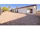 Spacious backyard with gravel ground cover, a covered patio, and mature trees, perfect for outdoor living and entertaining at 4454 Harmony Ct, Las Vegas, NV 89121