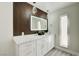Modern bathroom featuring double vanity, decorative accent wall, and unique pendant lighting at 4454 Harmony Ct, Las Vegas, NV 89121