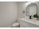 Elegant powder room featuring a marble countertop, black fixtures, a decorative mirror, and a modern design at 4454 Harmony Ct, Las Vegas, NV 89121