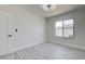 Neutral bedroom with wood-look flooring, large window, and contemporary lighting at 4454 Harmony Ct, Las Vegas, NV 89121