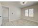 Bright bedroom with wood-look flooring, plantation shutters, and doorway at 4454 Harmony Ct, Las Vegas, NV 89121
