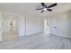 A bright bedroom offers wood-look floors and leads to the bathroom and closet through white paneled doors at 4454 Harmony Ct, Las Vegas, NV 89121