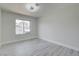 Bright bedroom featuring wood floors, modern lighting, and a large window at 4454 Harmony Ct, Las Vegas, NV 89121