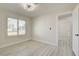 Bright bedroom with wood-look flooring, plantation shutters, and doorway at 4454 Harmony Ct, Las Vegas, NV 89121