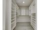 Walk-in closet features custom shelving, ample storage, and wood-look floors to coordinate with the bedroom at 4454 Harmony Ct, Las Vegas, NV 89121