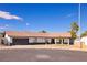 Charming single-story home featuring a tile roof, two-car garage, and well-maintained landscaping on a sunny day at 4454 Harmony Ct, Las Vegas, NV 89121