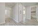 Hallway features wood-look floors, neutral paint, and access to the updated bathroom at 4454 Harmony Ct, Las Vegas, NV 89121