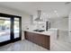 Open kitchen boasts stainless steel appliances, sleek cabinetry, and a breakfast bar with backyard views of the pool at 4454 Harmony Ct, Las Vegas, NV 89121