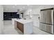 Modern kitchen featuring white cabinetry, stainless steel appliances, a center island, and an open layout at 4454 Harmony Ct, Las Vegas, NV 89121