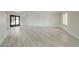 Spacious living area with modern light wood floors, large windows, and clean design aesthetic throughout the space at 4454 Harmony Ct, Las Vegas, NV 89121
