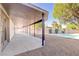 Spacious patio with covered area, gravel landscaping and views of the refreshing backyard pool at 4454 Harmony Ct, Las Vegas, NV 89121