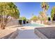 Inviting backyard pool with desert landscaping, trees and clear blue skies at 4454 Harmony Ct, Las Vegas, NV 89121