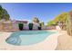 Sparkling backyard pool with cool clear water, desert landscaping and steps to enter at 4454 Harmony Ct, Las Vegas, NV 89121