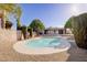 Backyard view of the pool with desert landscaping, trees and outdoor entertaining space at 4454 Harmony Ct, Las Vegas, NV 89121