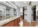 Bathroom featuring double sinks, granite counters, and mirrored closet at 4680 Freshwater Dr, Las Vegas, NV 89103