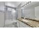 Renovated bathroom featuring new tile, updated fixtures, and granite countertops at 4680 Freshwater Dr, Las Vegas, NV 89103
