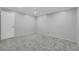 A cozy bedroom featuring neutral walls and soft gray carpeting at 4680 Freshwater Dr, Las Vegas, NV 89103