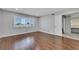 Neutral bedroom featuring a large window and hardwood floors at 4680 Freshwater Dr, Las Vegas, NV 89103