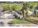 Charming single-Gathering home featuring a well-maintained lawn, mature trees, and an attached two-car garage at 4680 Freshwater Dr, Las Vegas, NV 89103