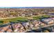 Wide aerial view of houses nestled alongside a golf course, blending residential living with recreational amenities at 4718 Atlantico St, Las Vegas, NV 89135