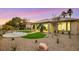 Idyllic backyard featuring desert landscaping, a custom lawn, and a covered patio in a serene outdoor space at 4718 Atlantico St, Las Vegas, NV 89135