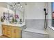 Modern bathroom featuring double vanity, wood cabinets, modern fixtures, and a large glass shower with grey tiling at 4718 Atlantico St, Las Vegas, NV 89135