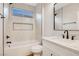 This bathroom boasts black hardware, neutral tiles, and a built-in shelf above the tub at 4718 Atlantico St, Las Vegas, NV 89135
