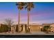 Inviting home exterior featuring manicured landscaping, palm trees, and a well-maintained driveway leading to a garage at 4718 Atlantico St, Las Vegas, NV 89135