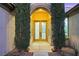 Close up of an elegant front door framed by manicured shrubs and featuring decorative glass panels at 4718 Atlantico St, Las Vegas, NV 89135
