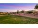 Inviting view of a well-maintained golf course with desert landscaping surrounding a single-story house in a serene community at 4718 Atlantico St, Las Vegas, NV 89135