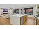 Open-concept kitchen with a waterfall island, stainless steel appliances, and a seamless flow to the living area at 4718 Atlantico St, Las Vegas, NV 89135
