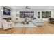 Bright living room with large windows, ceiling fan, fireplace, and modern furniture at 4718 Atlantico St, Las Vegas, NV 89135