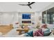 Spacious living room with a fireplace, large windows, and comfortable seating at 4718 Atlantico St, Las Vegas, NV 89135