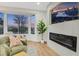 Sunlit living room with a bay window, modern fireplace, and stylish decor at 4718 Atlantico St, Las Vegas, NV 89135