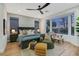 Well-lit main bedroom featuring a large window, a ceiling fan, and elegant decor for a comfortable retreat at 4718 Atlantico St, Las Vegas, NV 89135