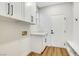 This mudroom features white shaker cabinets, coat hooks, and bench seating with storage at 4718 Atlantico St, Las Vegas, NV 89135