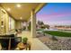 Covered patio with comfortable seating overlooking desert landscaping, a lawn, and a fire pit at 4718 Atlantico St, Las Vegas, NV 89135