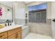 Modern shower with gray and white tiling, wood vanity, and shower bench at 4718 Atlantico St, Las Vegas, NV 89135