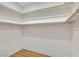 Spacious walk-in closet with wood rods and white shelving at 4718 Atlantico St, Las Vegas, NV 89135