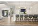 Elegant bar area with marble countertops, pendant lights, and views to the exterior at 5 Moonfire Dr, Las Vegas, NV 89135