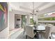 Bright dining area with a round table, sliding glass doors, and modern decor at 5 Moonfire Dr, Las Vegas, NV 89135