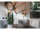 Modern dining area featuring stylish decor, artwork, and a view of outdoor greenery at 5 Moonfire Dr, Las Vegas, NV 89135