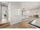 Bright hallway with modern railing and wood flooring, artful modern details and recessed lighting at 5 Moonfire Dr, Las Vegas, NV 89135