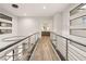 Bright hallway with modern railing and chandelier, with recessed lighting highlighting the home's design at 5 Moonfire Dr, Las Vegas, NV 89135