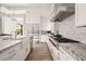 Well-equipped kitchen boasting white cabinets, marble countertops, stainless steel appliances, and a spacious layout at 5 Moonfire Dr, Las Vegas, NV 89135