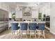 Modern kitchen featuring white cabinetry, a large island with counter seating, and stainless steel appliances at 5 Moonfire Dr, Las Vegas, NV 89135