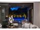 Seamless indoor-outdoor living with sliding glass doors open to a patio, pool, and cozy seating area at 5 Moonfire Dr, Las Vegas, NV 89135