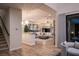 Bright and open living room with hardwood floors and comfortable seating, flowing seamlessly from the staircase at 5 Moonfire Dr, Las Vegas, NV 89135