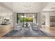 Bright open-concept living room showcasing modern lighting, wood floors, and seamless access to the outdoor patio at 5 Moonfire Dr, Las Vegas, NV 89135